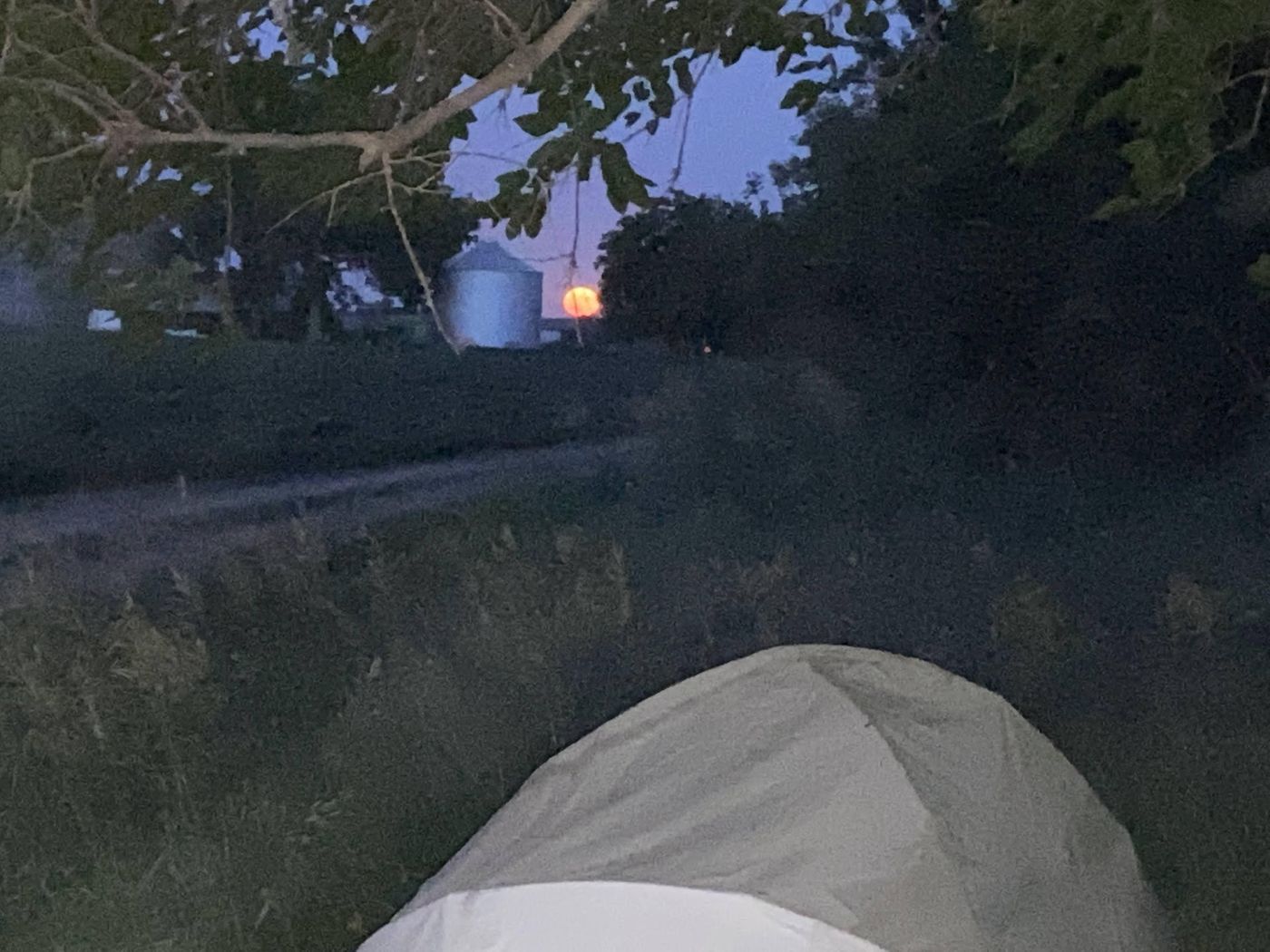 A tent at camp under the evening sky