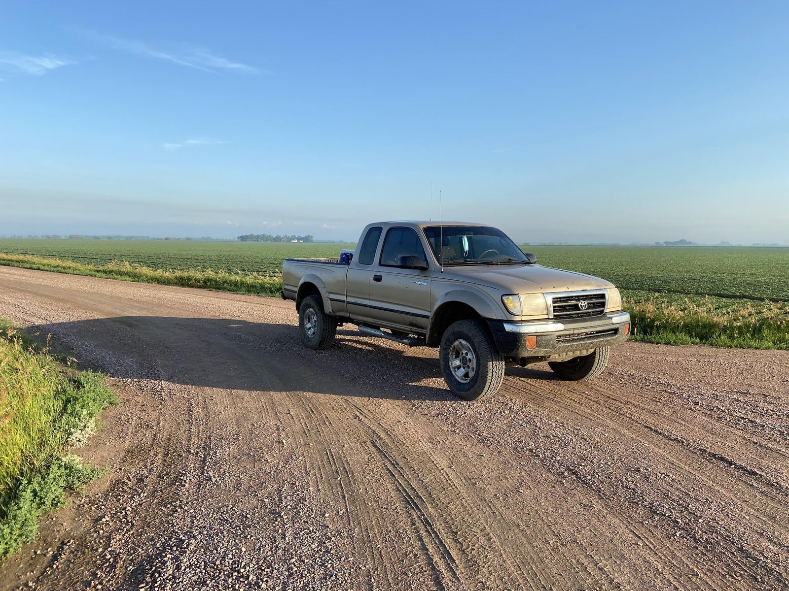 The crew truck parked on a gravel road at first light